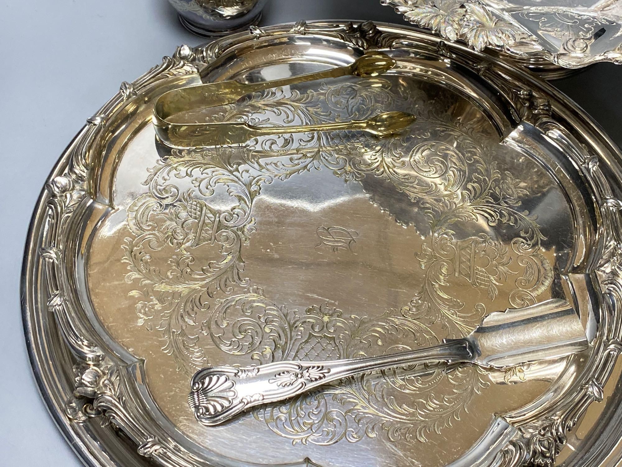 A silver plated cake basket, with cast border, diameter 31cm, two plated trays and three other items